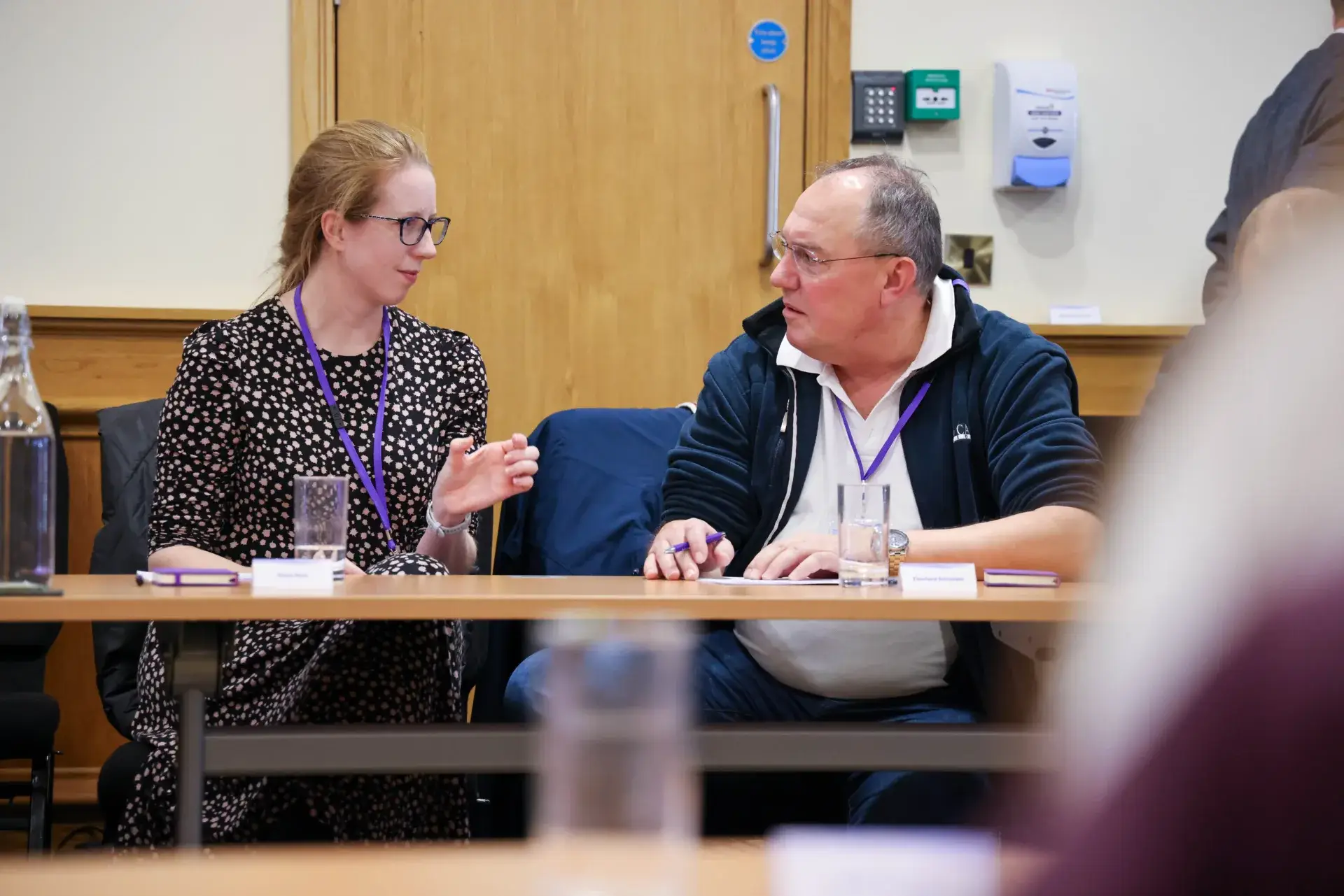 Two neonatal nurses speaking to eachother